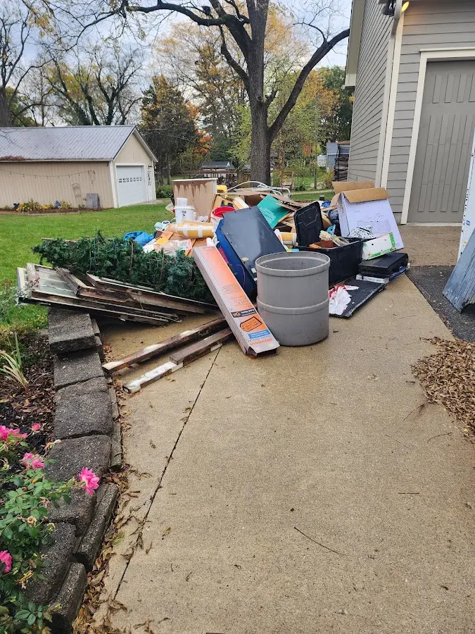 Dumpster being loaded with debris for 30 Yard Dumpster Rental in Middleville